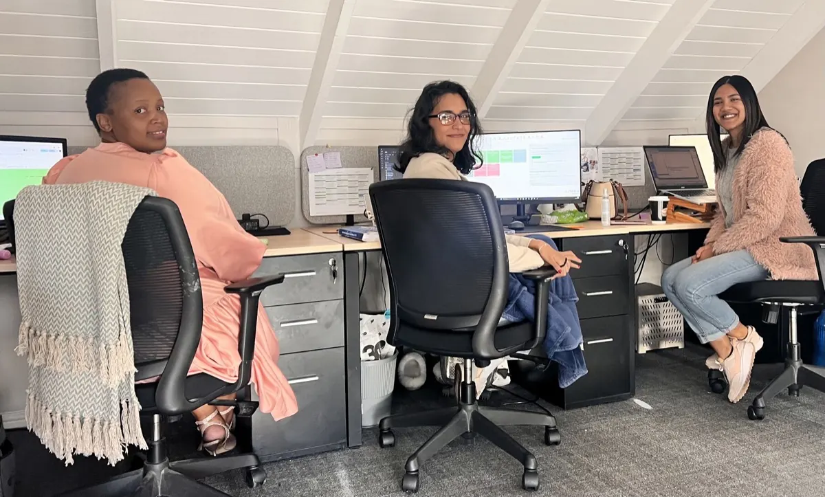 Uzzie, Nicol and Robyn at their desks in the billing office