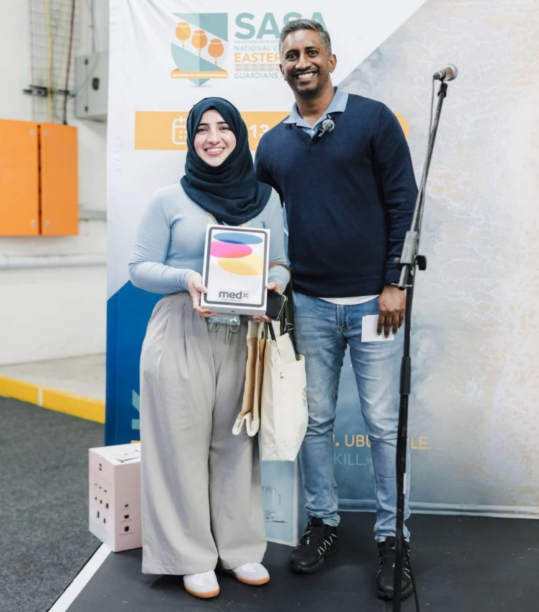 The Guardian&rsquo;s Challenge winner holding the iPad donated by MedX at the 2026 SASA Congress